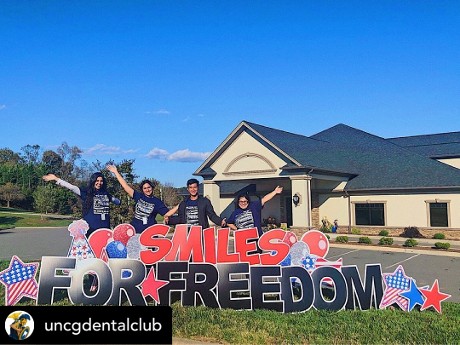 People and Smiles For Freedom Sign